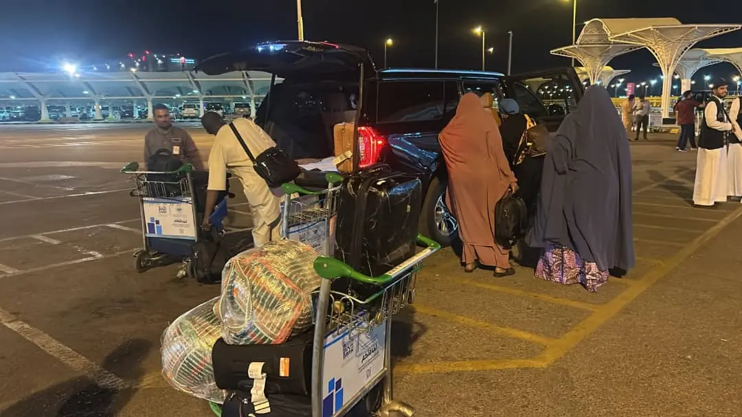 Luggage being loaded into a vehicle at the airport for transfer